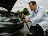 Doctor using electric paddles to revive a car — symbol of the company car’s electric comeback